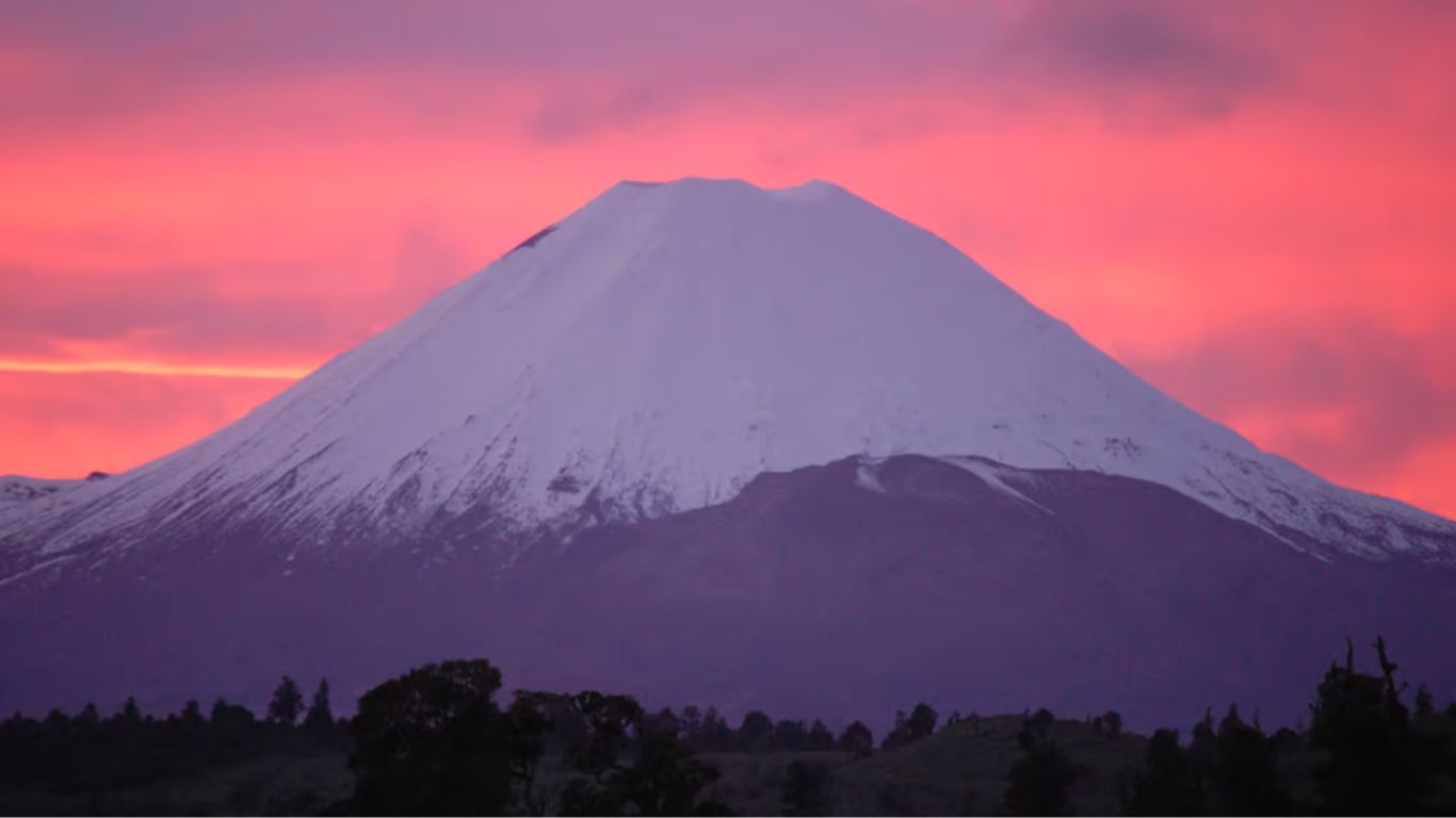 Scenic view of the Tongariro Alpine Crossing trail, featuring volcanic landscapes, emerald lakes, and rugged mountain terrain.